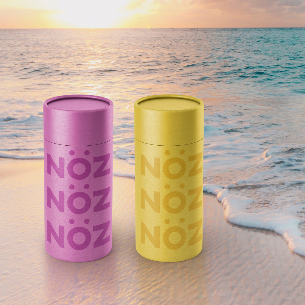 NOZ Nozscreen in yellow, and purple, on the beach.